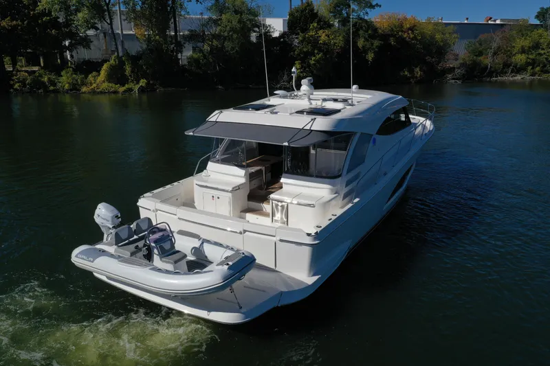 Slide: The Image of 2025 Riviera 465 SUV luxury yacht cruising on a serene river. - 8