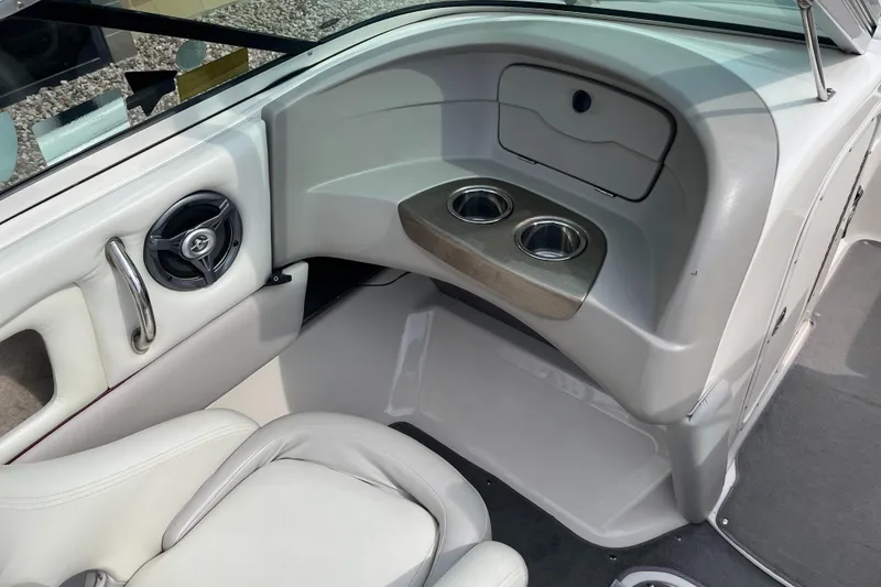 Slide: The Image of Interior of a 2008 Bryant 239 boat with cup holders and seating. - 10