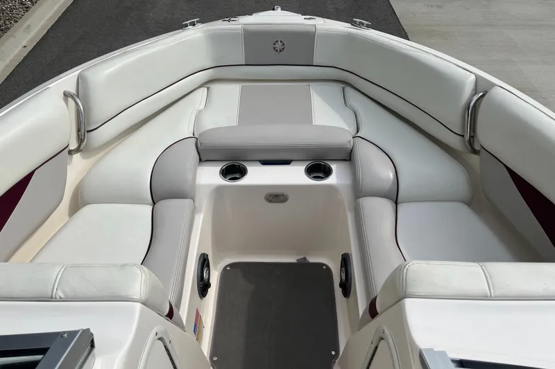 Slide: The Image of 2008 Bryant 239 boat interior with white seating and cup holders. - 11