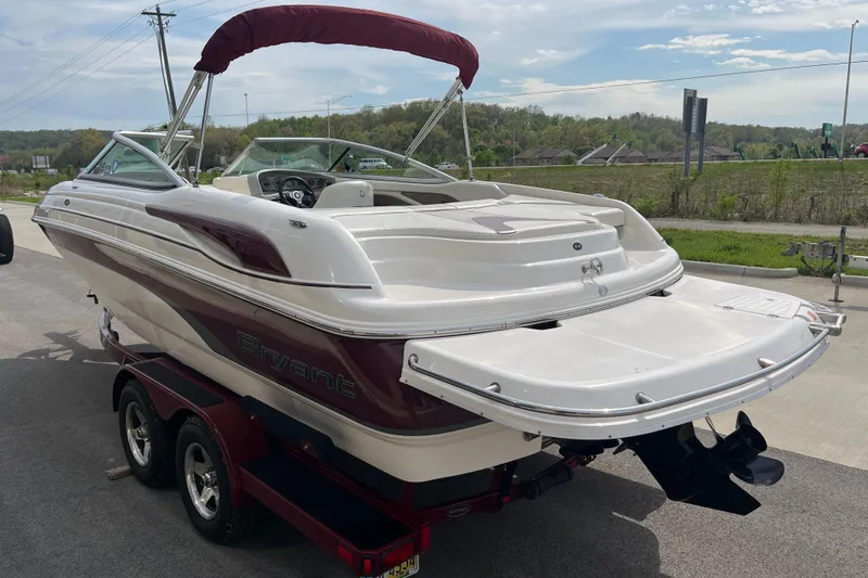 Slide: The Image of 2008 Bryant 239 boat on trailer, white and maroon, parked outdoors. - 5