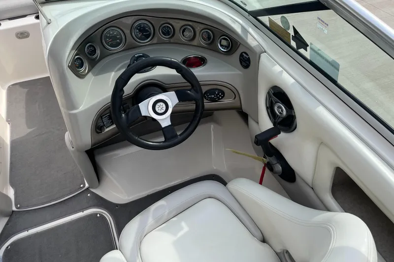 Slide: The Image of 2008 Bryant 239 boat dashboard with steering wheel and control panel. - 9