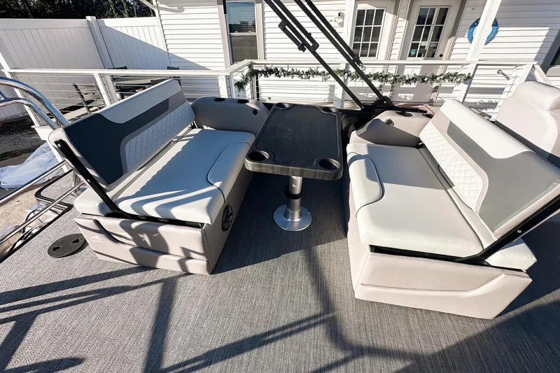 Slide: The Image of Interior of 2025 Godfrey Sweetwater 24' Tritoon, featuring helm and seating area. - 11