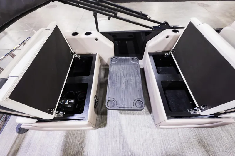 Slide: The Image of 2025 Godfrey Sweetwater 24' Tritoon with open storage compartments and drop table. - 16