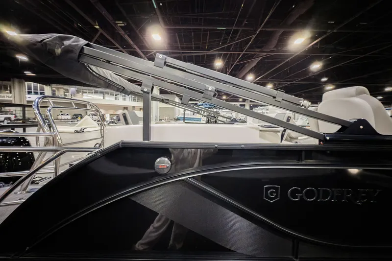 Slide: The Image of 2025 Godfrey Sweetwater 24' Drop Table Lounge Tritoon showcased indoors. - 23