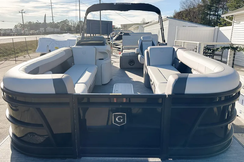 Slide: The Image of 2025 Godfrey Sweetwater 24' Tritoon with drop table lounge, sleek design, spacious seating. - 27