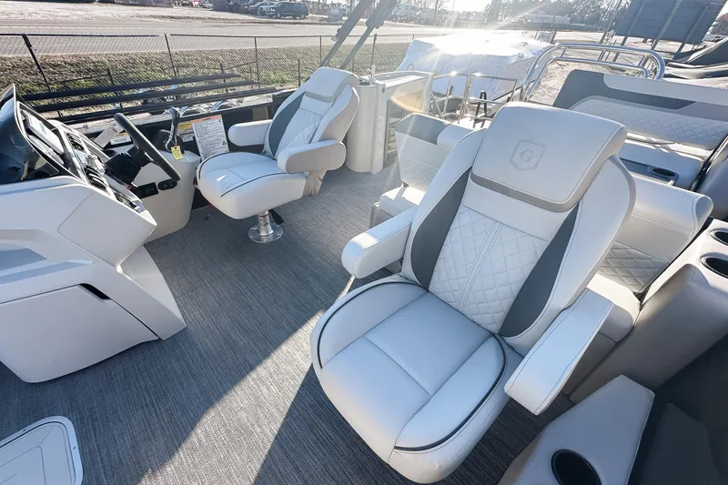 Slide: The Image of 2025 Godfrey Sweetwater 24' Tritoon interior with luxurious seating and modern helm. - 8