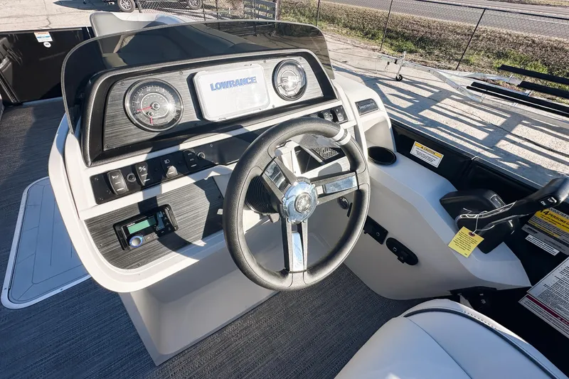 Slide: The Image of 2025 Godfrey Sweetwater 24' Tritoon boat interior with modern helm and plush seating. - 9