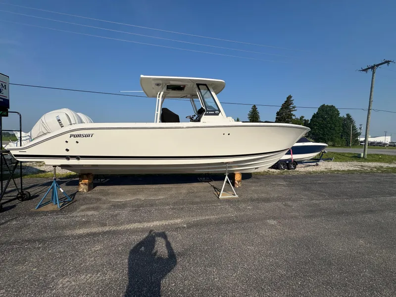 The Image of 2025 Pursuit S 288 Sport boat on display outdoors, side view. - 1