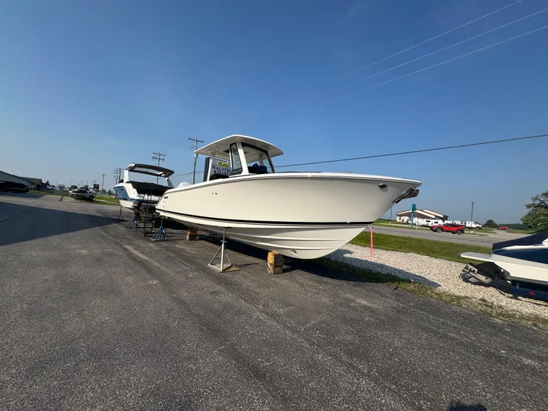 Slide: The Image of 2025 Pursuit S 288 Sport boat displayed outdoors on a sunny day. - 2