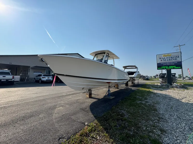 Slide: The Image of 2025 Pursuit S 288 Sport boat displayed at a marine dealership. - 3