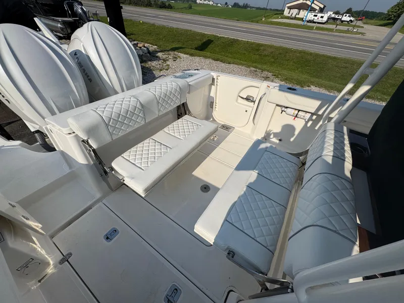 Slide: The Image of 2025 Pursuit S 288 Sport boat interior with white quilted seating and dual engines. - 5
