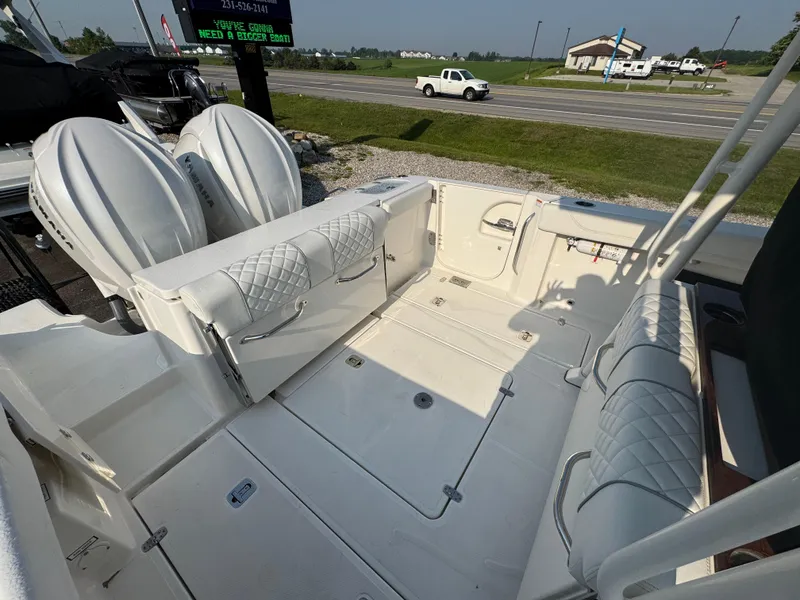 Slide: The Image of 2025 Pursuit S 288 Sport boat interior with cushioned seating and dual engines. - 6