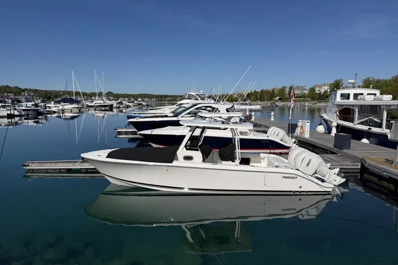 The Image of 2025 Pursuit S 288 Sport boat docked in a serene marina setting. - 0