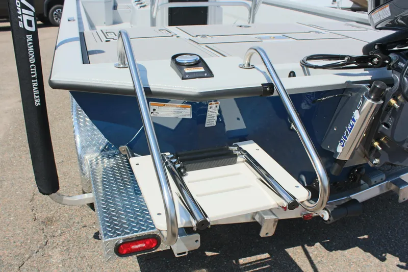 Slide: The Image of 2025 Avid 23 FSX boat with rear ladder and motor, on trailer. - 11