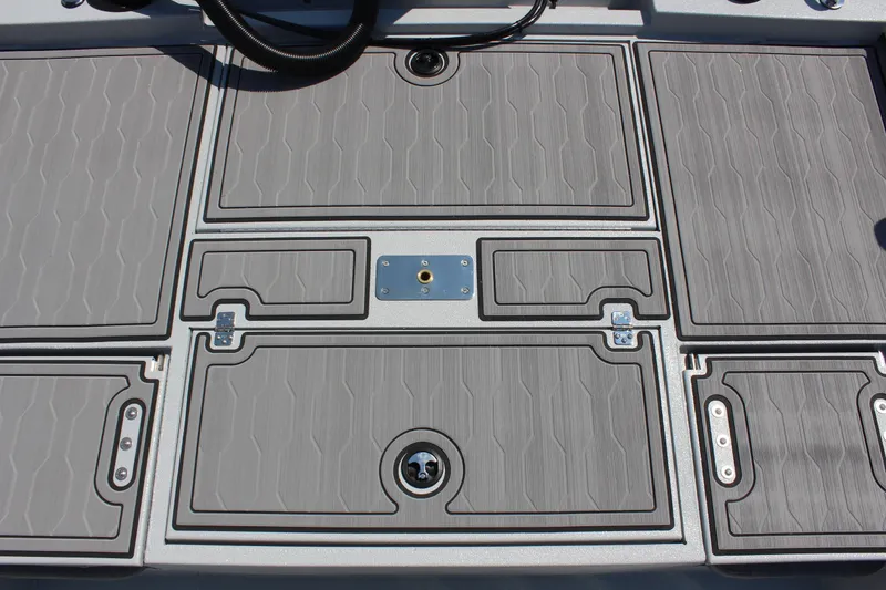 Slide: The Image of Avid 23 FSX 2025 boat deck with textured panels and storage compartments. - 12
