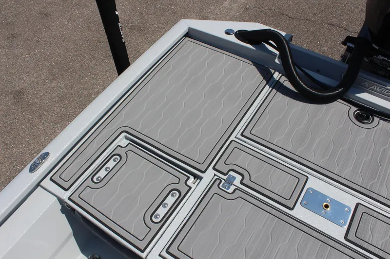 Slide: The Image of 2025 Avid 23 FSX boat deck with textured gray panels and storage compartments. - 13