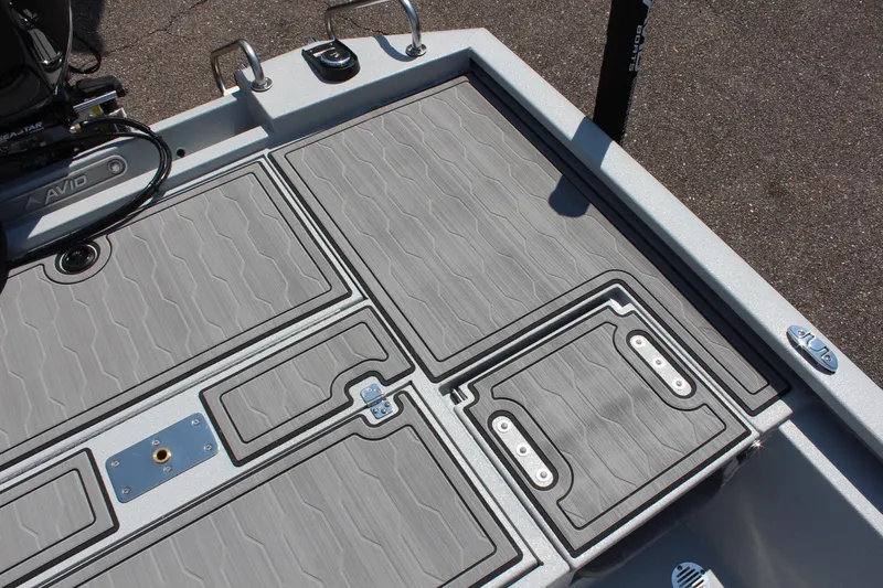 Slide: The Image of 2025 Avid 23 FSX boat deck with textured gray panels and storage compartments. - 14