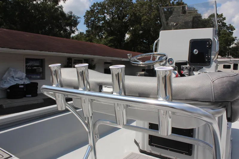 Slide: The Image of 2025 Avid 23 FSX boat interior with rod holders and steering console. - 18