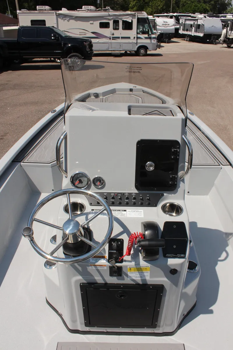 Slide: The Image of 2025 Avid 23 FSX boat console with steering wheel and controls. - 19