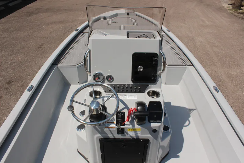 Slide: The Image of 2025 Avid 23 FSX boat console with steering wheel and controls. - 20