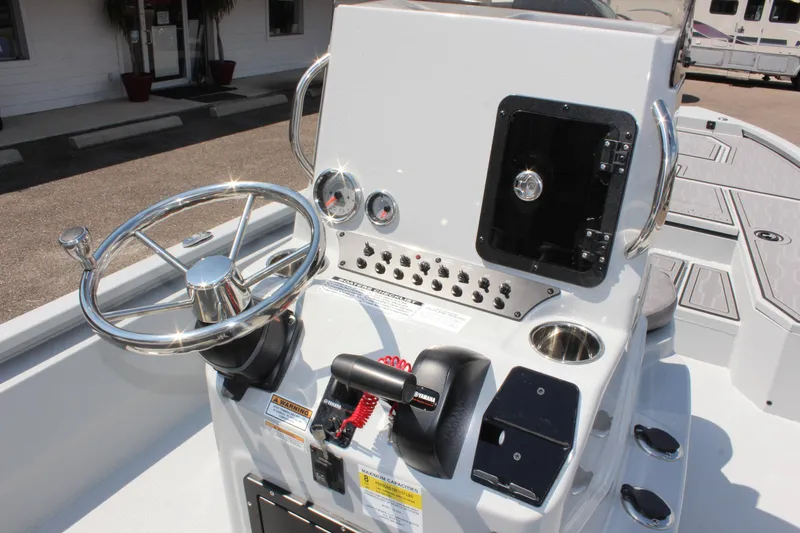 Slide: The Image of 2025 Avid 23 FSX boat console with steering wheel and control panel. - 22