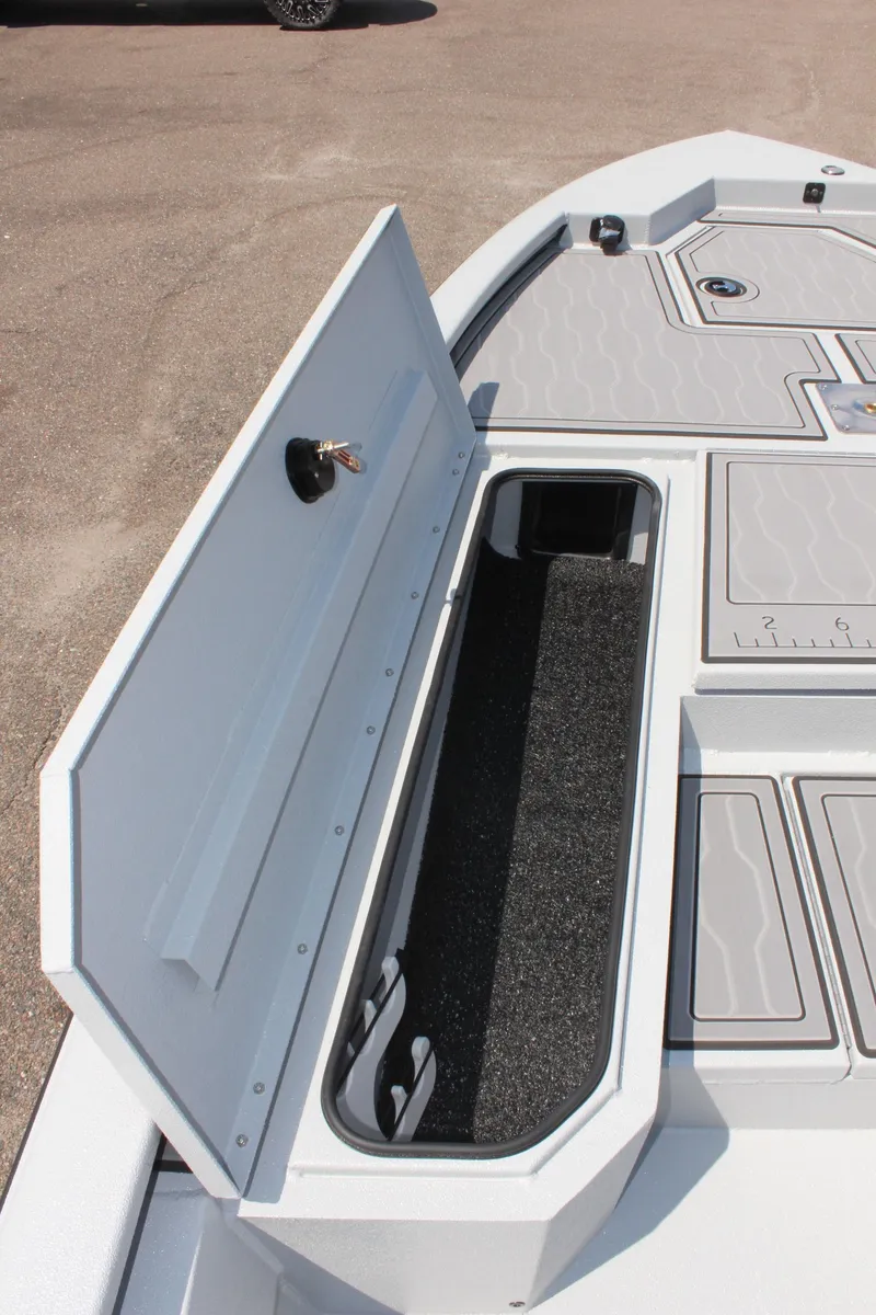 Slide: The Image of 2025 Avid 23 FSX boat storage compartment with open lid. - 31