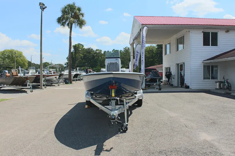 Slide: The Image of 2025 Avid 23 FSX boat on trailer outside dealership. - 4