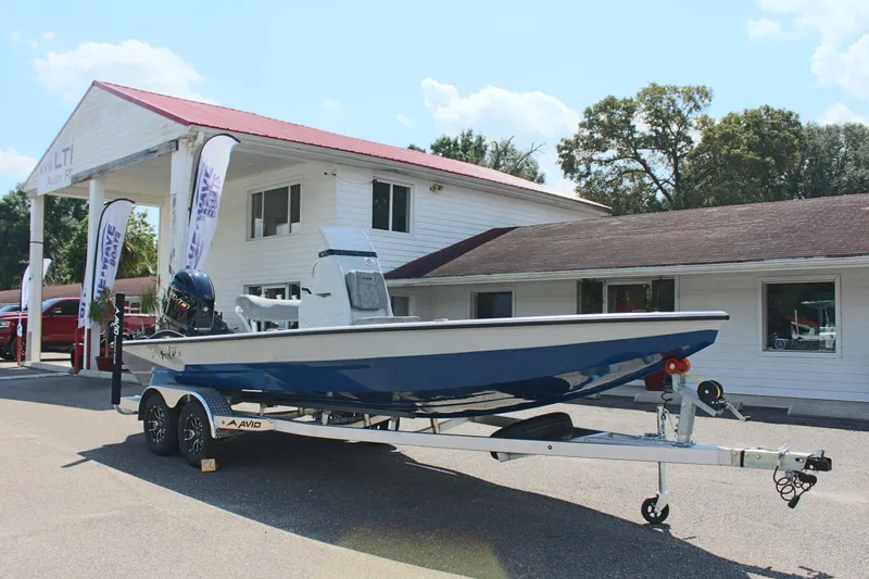 Slide: The Image of 2025 Avid 23 FSX boat on trailer outside dealership. - 5