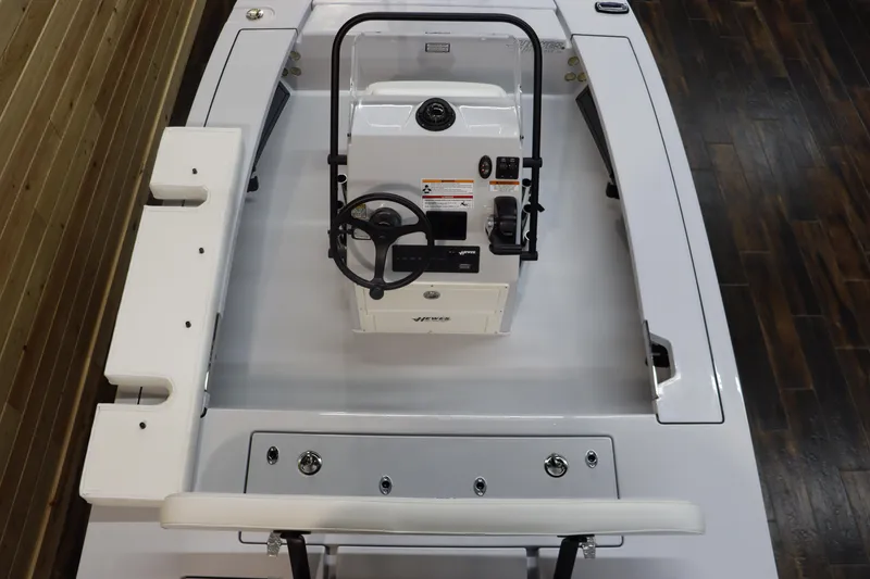 Slide: The Image of 2025 Hewes 16 Redfisher boat interior with steering console and seating. - 13
