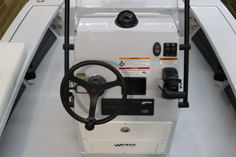 Slide: The Image of 2025 Hewes 16 Redfisher boat console with steering wheel and controls. - 15