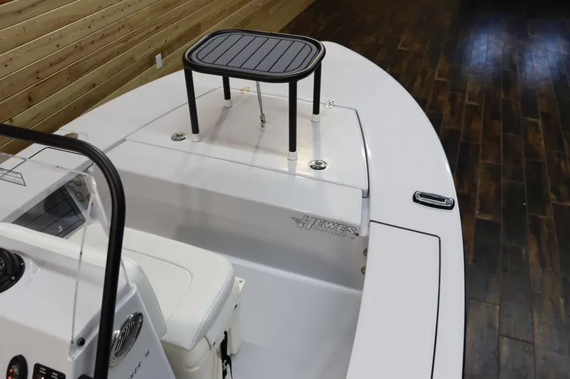Slide: The Image of 2025 Hewes 16 Redfisher boat interior with seating and console. - 16