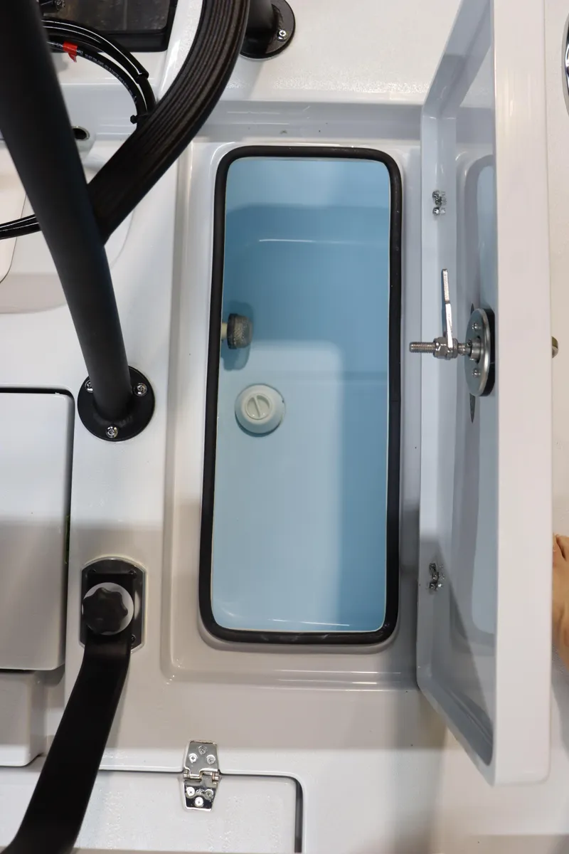 Slide: The Image of 2025 Hewes 16 Redfisher boat storage compartment with open lid. - 19