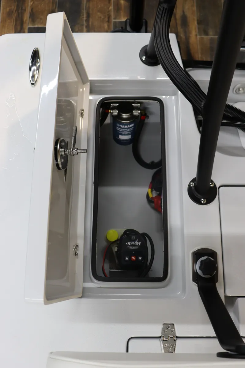 Slide: The Image of 2025 Hewes 16 Redfisher boat compartment with battery and wiring. - 21