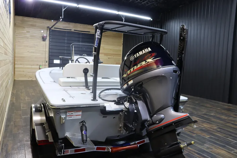 Slide: The Image of 2025 Hewes 16 Redfisher boat with Yamaha engine in a showroom. - 4