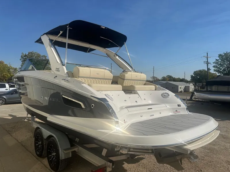 Slide: The Image of 2023 Regal 2800 boat with sleek design on a trailer, sunny day. - 10