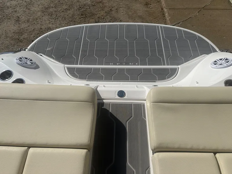 Slide: The Image of 2023 Regal 2800 boat interior with beige seating and sleek deck design. - 12