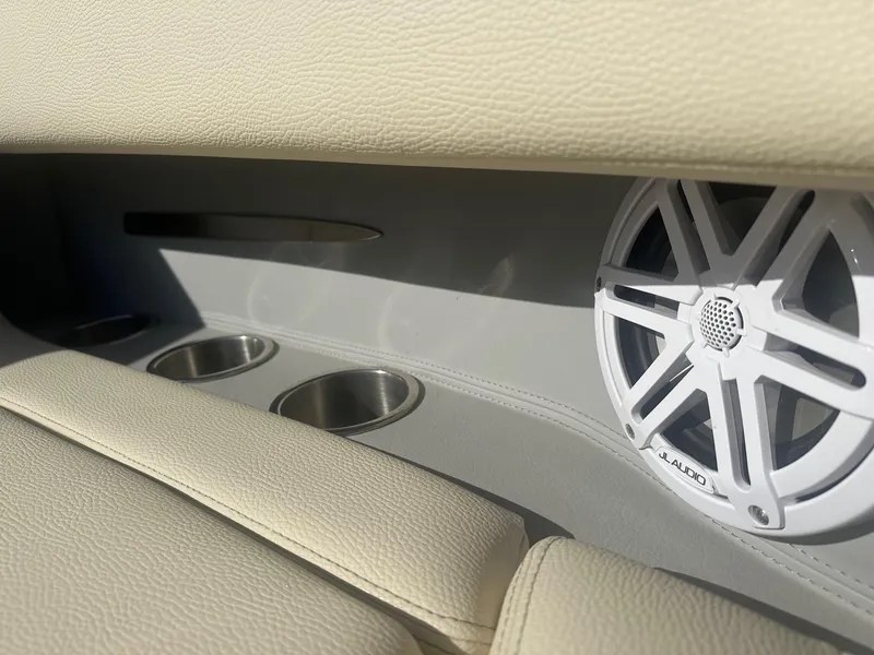 Slide: The Image of 2023 Regal 2800 boat interior with JL Audio speaker and cup holders. - 13