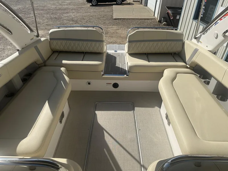 Slide: The Image of 2023 Regal 2800 boat interior with beige seating and spacious layout. - 17