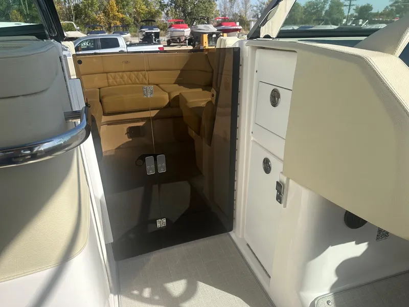Slide: The Image of 2023 Regal 2800 boat interior with beige seating and sleek design. - 18