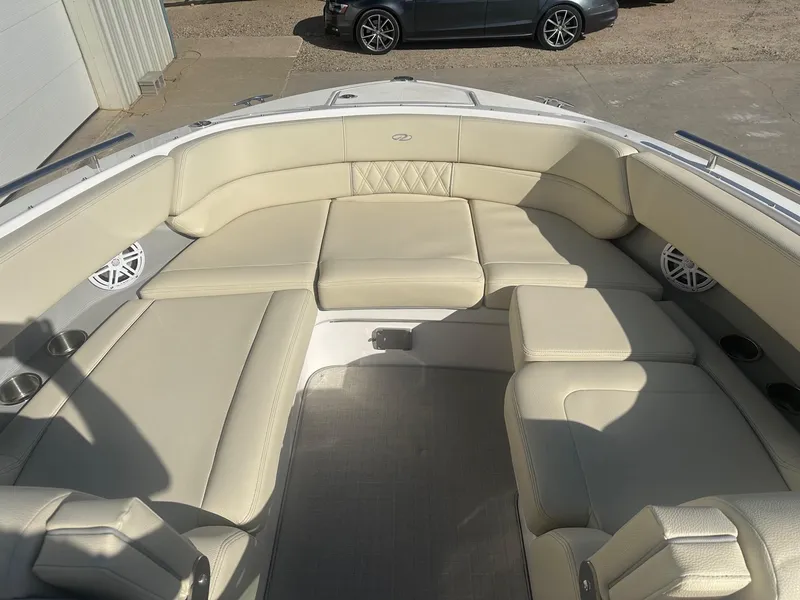Slide: The Image of 2023 Regal 2800 boat interior with beige seating and cup holders. - 20