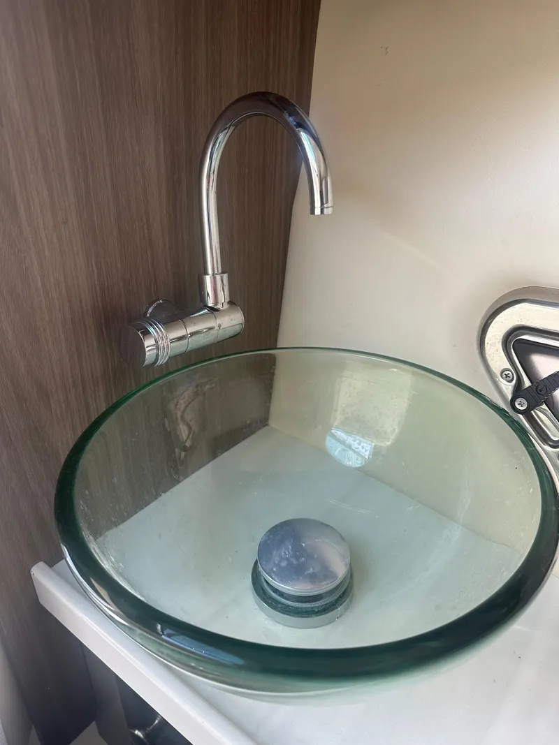 Slide: The Image of Glass sink with modern faucet in 2023 Regal 2800 boat interior. - 21