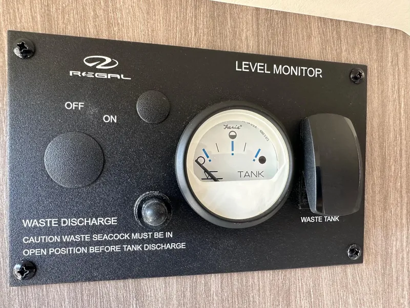 Slide: The Image of Regal 2800 2023 waste tank level monitor with on/off switch and caution notice. - 22