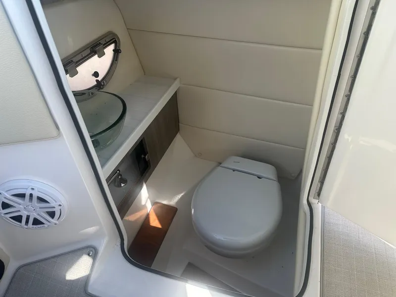 Slide: The Image of 2023 Regal 2800 boat interior bathroom with modern toilet and sink. - 24