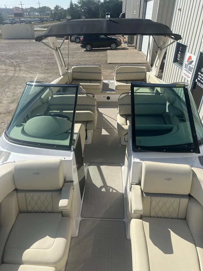 Slide: The Image of 2023 Regal 2800 boat interior with beige seating and black canopy. - 25