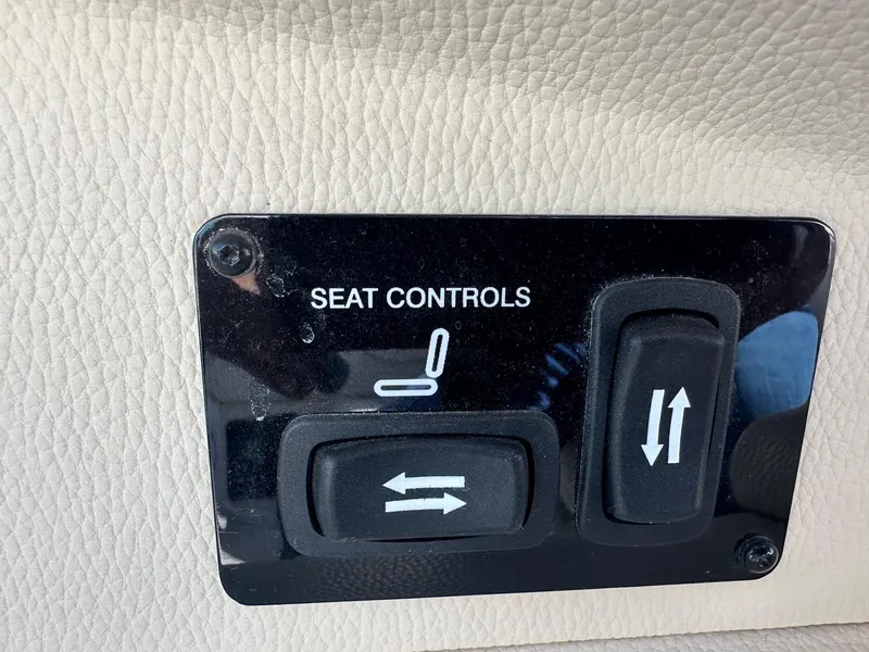 Slide: The Image of 2023 Regal 2800 seat controls on beige leather interior panel. - 26