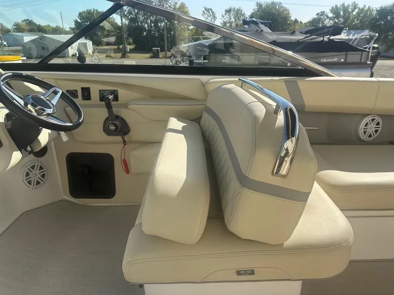 Slide: The Image of 2023 Regal 2800 boat interior with beige seating and steering wheel. - 27