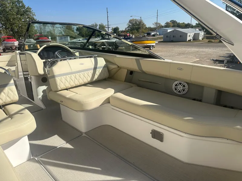 Slide: The Image of 2023 Regal 2800 boat interior with beige seating and steering wheel. - 29