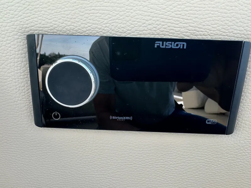 Slide: The Image of Fusion audio control panel on 2023 Regal 2800 boat dashboard. - 36