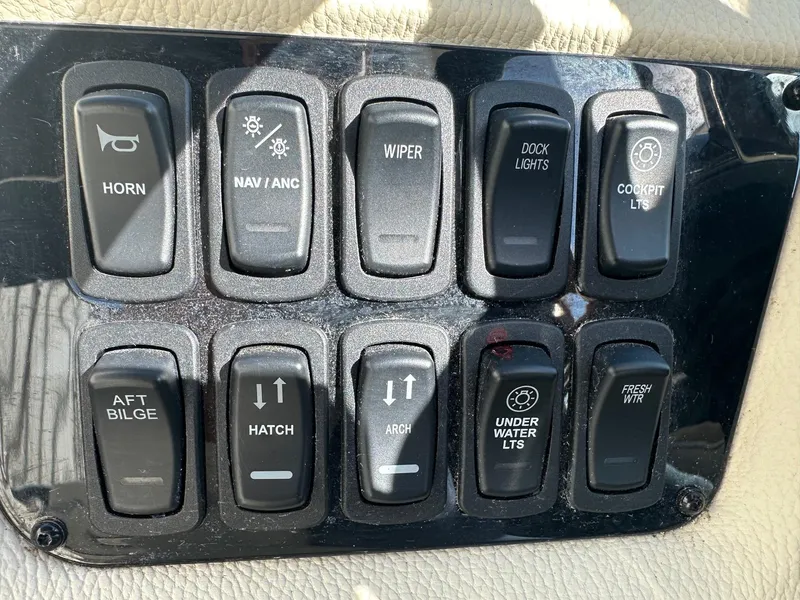 Slide: The Image of Control panel of a 2023 Regal 2800 boat with various switches. - 37