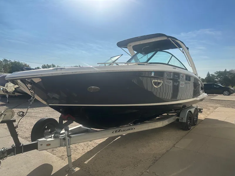 Slide: The Image of 2023 Regal 2800 boat on trailer under clear blue sky. - 4